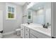 Bathroom with double vanity, tile floors, and a window providing natural light at 105 Shawnee Drive, Louisburg, NC 27549