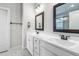 Bathroom with double vanity, granite countertops, framed mirrors, and tiled flooring at 105 Shawnee Drive, Louisburg, NC 27549