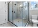 Bathroom featuring seamless glass shower, tiled walls and floors, and a toilet at 105 Shawnee Drive, Louisburg, NC 27549