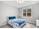 Cozy bedroom with natural light from the window, floral pattern comforter and closet at 105 Shawnee Drive, Louisburg, NC 27549