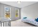 Bright bedroom features a crib, a bed, and a window that provides plenty of natural light at 105 Shawnee Drive, Louisburg, NC 27549