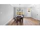 Dining room features a wooden table with view of the front yard, and entry door at 105 Shawnee Drive, Louisburg, NC 27549