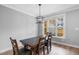 Dining area with wood floors, a modern lighting fixture and large windows at 105 Shawnee Drive, Louisburg, NC 27549