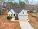Charming white home with a well-manicured front yard, two-car garage, and inviting curb appeal at 105 Shawnee Drive, Louisburg, NC 27549
