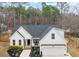 Charming white home with a well-maintained front yard and attached two-car garage, perfect for suburban living at 105 Shawnee Drive, Louisburg, NC 27549