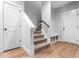 Hallway with LVP floors, carpeted stairs, storage cubbies and white doors at 105 Shawnee Drive, Louisburg, NC 27549