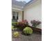 Beautiful landscaping with vibrant red roses and lush greenery around the home's exterior at 105 Shawnee Drive, Louisburg, NC 27549