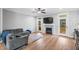 Spacious living room features a fireplace and access to an outdoor space through glass doors at 105 Shawnee Drive, Louisburg, NC 27549