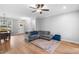Bright living room with wood floors, dining area, sofa, and plenty of natural light at 105 Shawnee Drive, Louisburg, NC 27549