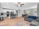 Bright, open-concept living space with kitchen island, hardwood floors and stainless steel appliances at 105 Shawnee Drive, Louisburg, NC 27549