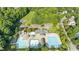 Aerial view of a community pool with waterslides, lap pool, splash pool, umbrellas, and a clubhouse at 108 Branchside Ln, Holly Springs, NC 27540