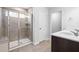 Bright bathroom showcasing a glass shower enclosure and dual sink vanity at 1103 Freestone Rd, Durham, NC 27703