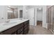 Bathroom features a double sink vanity, a glass-enclosed shower, and tile flooring at 1103 Freestone Rd, Durham, NC 27703