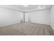 A bright bedroom shows carpeting and multiple doorways offering flexible space at 1103 Freestone Rd, Durham, NC 27703
