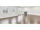 Bright living area featuring hardwood floors, a fireplace, and natural light pouring through large windows and glass panel back door at 1103 Freestone Rd, Durham, NC 27703