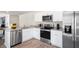 Modern kitchen featuring stainless steel appliances, granite countertops, and white cabinets at 111 Holmes Corner Dr, Smithfield, NC 27577