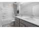 Modern bathroom featuring a double vanity with gray cabinets, white countertops, and a shower-tub combo at 1113 Freestone Rd, Durham, NC 27703