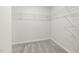 Organized walk-in closet featuring white wire shelving and neutral carpeting, providing ample storage space at 1113 Freestone Rd, Durham, NC 27703