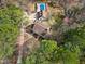 Overhead view of home and pool house with pristine pool, nestled in lush, mature landscaping at 112 Hartland Ct, Raleigh, NC 27614