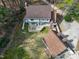 Aerial view of a home with a large deck and manicured lawn, detached garage, and in-ground pool at 112 Hartland Ct, Raleigh, NC 27614