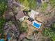 Overhead view of a home with an in-ground pool and detached garage surrounded by trees at 112 Hartland Ct, Raleigh, NC 27614