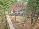 Aerial view of a two-story home surrounded by mature trees with long driveway at 112 Hartland Ct, Raleigh, NC 27614