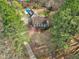 Aerial view of a two-story home with a pool, driveway, and surrounded by lush trees at 112 Hartland Ct, Raleigh, NC 27614