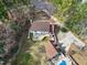 An aerial view showcases a home, deck, manicured lawn, and detached garage with a pool at 112 Hartland Ct, Raleigh, NC 27614