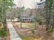 Aerial view of a two-story home surrounded by mature trees with long driveway at 112 Hartland Ct, Raleigh, NC 27614