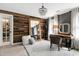 Bright bedroom features wood accent wall, elegant chandelier, and neutral decor at 112 Hartland Ct, Raleigh, NC 27614