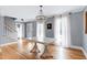 Spacious dining room showcasing hardwood floors, a chandelier, and an abundance of natural light at 112 Hartland Ct, Raleigh, NC 27614