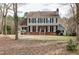 Traditional two-story home with a brick facade, complemented by mature trees and landscaping at 112 Hartland Ct, Raleigh, NC 27614