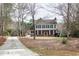 Charming two-story home with mature trees and a long driveway at 112 Hartland Ct, Raleigh, NC 27614