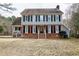 Charming two-story home featuring a brick foundation, gray siding, and classic black shutters at 112 Hartland Ct, Raleigh, NC 27614