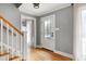 Welcoming foyer featuring hardwood floors, staircase, and a glass-paneled front door at 112 Hartland Ct, Raleigh, NC 27614