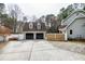 Spacious driveway leading to a detached two-car garage with dormers at 112 Hartland Ct, Raleigh, NC 27614