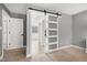 Bright hallway featuring a sliding door, modern lighting, and neutral wall paint at 112 Hartland Ct, Raleigh, NC 27614