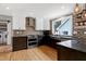 Bright kitchen with white and dark wood cabinets, stainless steel appliances, and farmhouse sink at 112 Hartland Ct, Raleigh, NC 27614