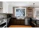 Modern kitchen featuring stainless steel appliances, custom cabinetry, and a large sink at 112 Hartland Ct, Raleigh, NC 27614