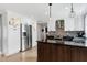 Spacious kitchen featuring a custom island, stainless steel refrigerator, and ample cabinet space at 112 Hartland Ct, Raleigh, NC 27614