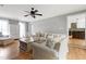 Bright living room boasts hardwood floors, ample seating, and view to the kitchen at 112 Hartland Ct, Raleigh, NC 27614