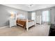 Main bedroom featuring a large bed, modern dresser, and natural lighting through the windows at 112 Hartland Ct, Raleigh, NC 27614