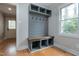 Mud room features a custom built in bench with storage and coat rack near the back door at 112 Hartland Ct, Raleigh, NC 27614