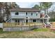The rear exterior of the home features a lovely new back deck overlooking the yard at 112 Hartland Ct, Raleigh, NC 27614