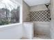 Shower featuring a modern design, neutral tile, and natural lighting through a window at 112 Hartland Ct, Raleigh, NC 27614