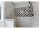 Modern bathroom shower featuring decorative tile accent and dark fixtures at 112 Hartland Ct, Raleigh, NC 27614