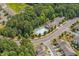 Aerial view of community pool surrounded by lush greenery, neighborhood streets, and homes at 114 Mt Evans Dr, Durham, NC 27705