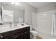 Bathroom features a large mirror, vanity, toilet, and a shower-tub combo with white shower curtain at 114 Mt Evans Dr, Durham, NC 27705
