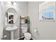 Cozy half bath with a pedestal sink, modern toilet, and stylish décor at 114 Mt Evans Dr, Durham, NC 27705