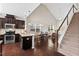 Open kitchen with stainless steel appliances, granite countertops, and hardwood floors at 114 Mt Evans Dr, Durham, NC 27705